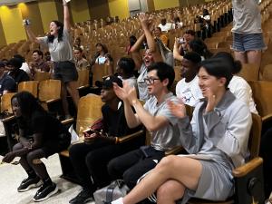 Civic Changemaker interns clap and cheer for presenting DCPS students