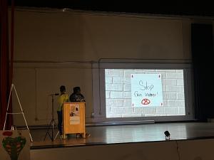 Sousa Middle School students present on a stage about an anti gun violence campaign