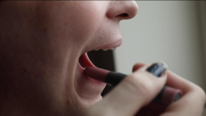 woman applies lipstick