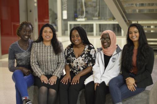 Group of 5 women sitting on a bench in SEH
