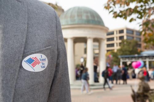 blazer on a person's chest with i voted sticker