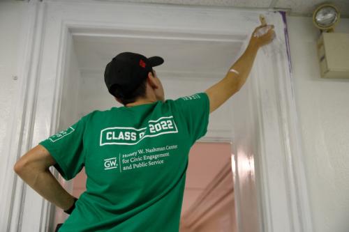 Student painting during Freshman Day of Service 2018